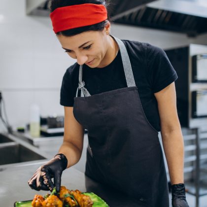 Female cook at the kitchen in a cafe